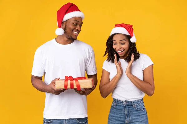 Boyfriend Giving Christmas Gift To Girlfriend Celebrating Holidays In Studio