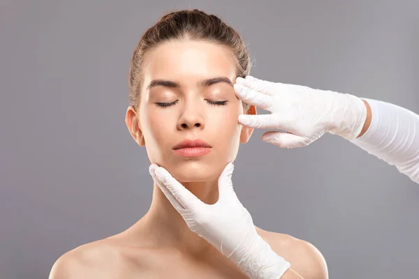 Attractive young woman getting treatment at beauty clinic Stock Image