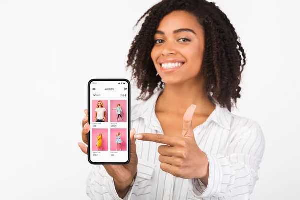 Black girl showing phone with online fashion store website