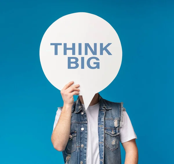 Guy covering face with speaking bulb with think big text