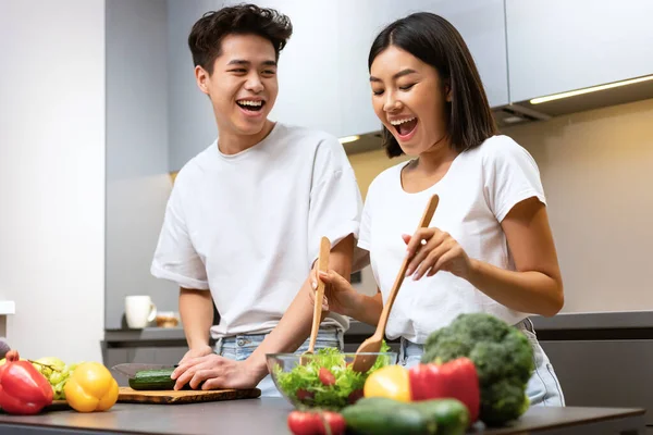 Chinese Couple Cooking Food And Laughing In Kitchen At Home — Stock Photo, Image