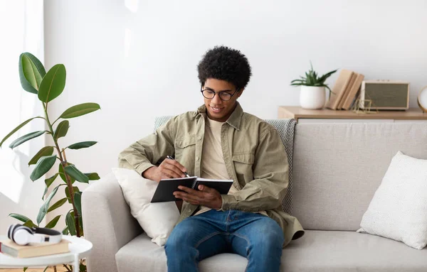 Remote education concept. Black teen college student studying from home during quarantine