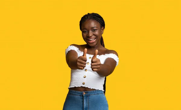 Ça me plaît. Souriant afro-américaine montrant pouces à la caméra — Photo