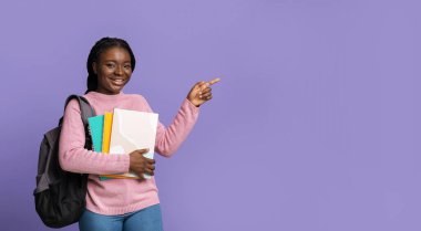 Genç siyah kız öğrenci parmak ile fotokopi alanını işaret ediyor.