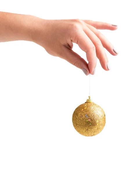 Woman holding golden xmas ball in hand, isolated on white — Stock Photo, Image