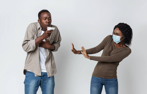 African american woman in face mask afraid of coughing woman