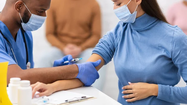 Mujer embarazada que recibe la inyección de vacuna Covid-19 en la sala de la clínica — Foto de Stock