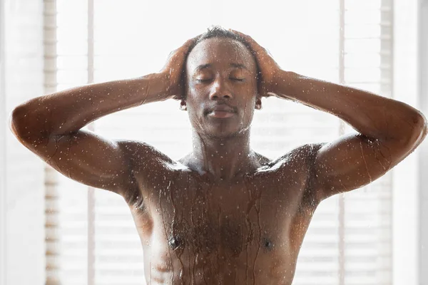 Muscular Black Guy Washing Enjoying Morning Shower In Modern Bathroom — Stock Photo, Image