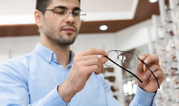 Porträt eines ernsthaften jungen Mannes, der sich für eine Brille entscheidet — Stockfoto