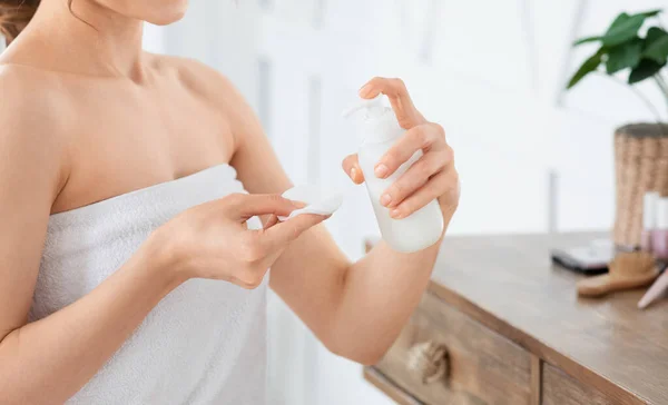 Mujer irreconocible limpiándose la cara con leche limpiadora —  Fotos de Stock