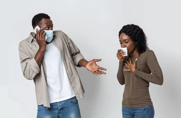 Scared black guy calling doctor, his girlfriend cughing — Stock Photo, Image