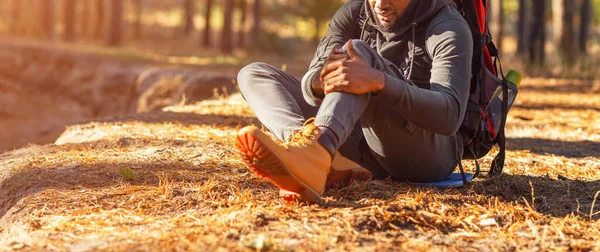 Cropped of black man rubbing his injured knee