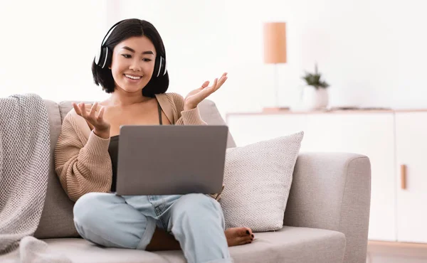 Happy asian lady using laptop for video call and talking — Stock Photo, Image