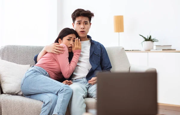 Asian Family Couple Watching Scary Movies On Laptop At Home