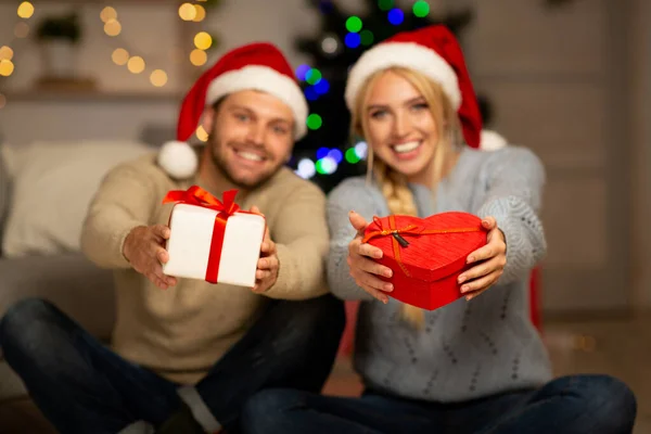 New Year presents in smiling couple hands