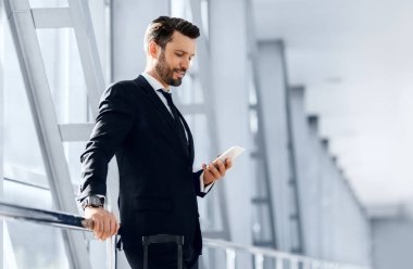 Yakışıklı sakallı iş adamı uçuş beklerken e- postaları kontrol ediyor