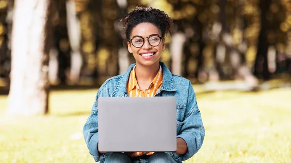 African Student Lady With Laptop Working On Computer Sitting Outdoor