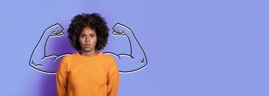 Kendinden emin bir Afrikalı Amerikalı kadın panoramik mor bir arka plana karşı duruyor. Yaratıcı bir kolaj tasarımı sayesinde pazı ve güç gösterisi yapıyor. Sahne, ruhu ve güçlendirmeyi temsil eder..