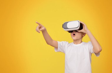 Vay canına, onun şaşırtıcı. Sanal gerçeklik yaşıyor, turuncu studio arka planda, kopya alanı el hareketi çocuk