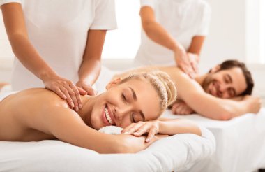 Haftasonu kapalı bir kaplıcada gözleri ile yatakta uzanmanın tadını çıkartan rahat bir çift sırt masajı alıyor. Eşler için rahatlama, güzellik ve sağIık prosedürü. Seçici odak