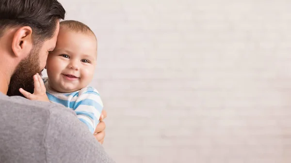 Loving Father Embracing His Cute Baby Son Holding Parenthood Stock Photo