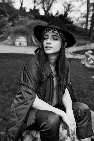 Şık şapka ve açık havada poz şık genç kadın fotoğrafı siyah-beyaz