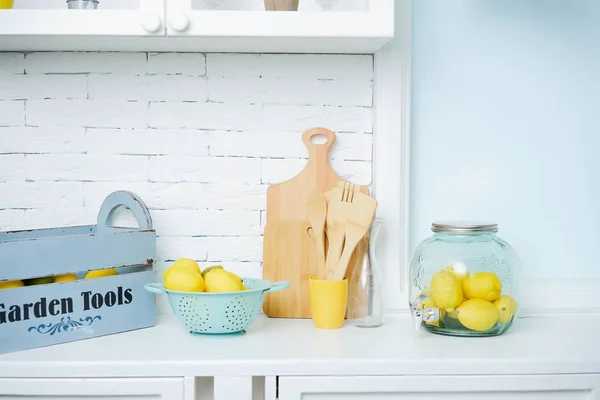 Fresh delicious lemons and Kitchen accessories on table