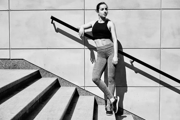 merdivenlerin üzerinde duran sportif genç esmer kadın            