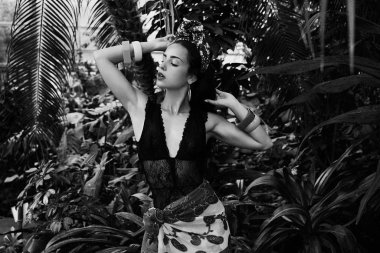 çeşitli bilezik açık havada poz ile zarif headdress içinde çekici genç kadın siyah beyaz fotoğraf 