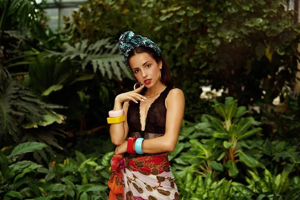 stock image attractive young woman in elegant headdress with various bracelets posing outdoors 