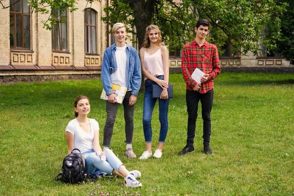 College students    with books at the school courtyard