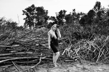  Genç Sarışın kadın doğası üzerine siyah elbise poz