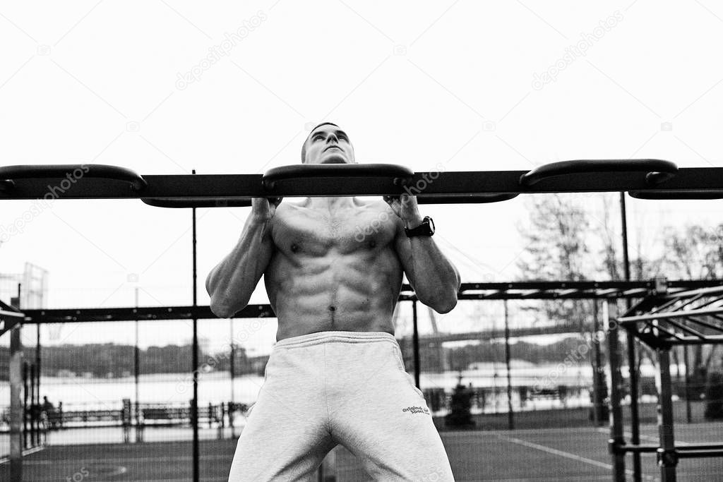 young man exercising on street with naked torso .fitness, sport, training and lifestyle concept 