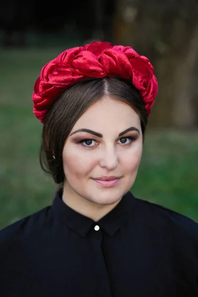 Gorgeous young woman in outstanding headdress posing