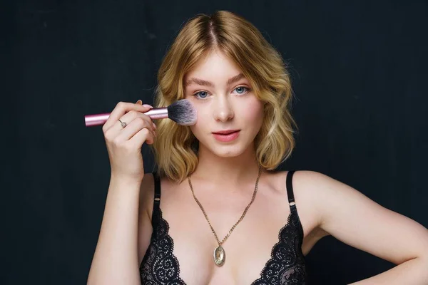 Beautiful Young Woman Applying Makeup Stock Photo