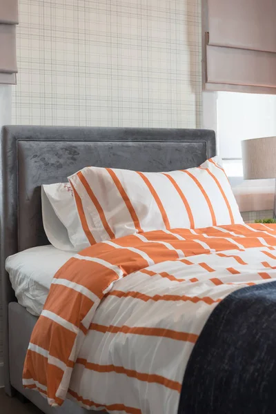 single bed in modern bedroom with orange and white color tone, interior design concept