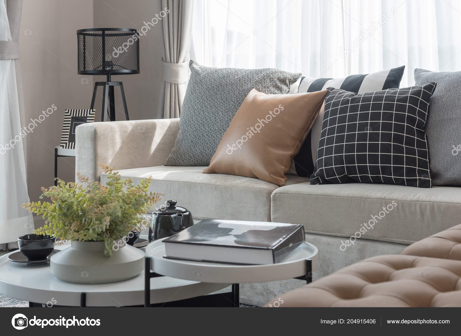 Comfy sofa with pillows in living room Stock Photo by