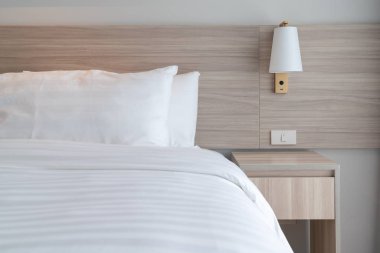 Ahşap yatak ve beyaz renk tonu yastıklar, iç tasarım dekorasyon konsepti dizi modern yatak odası