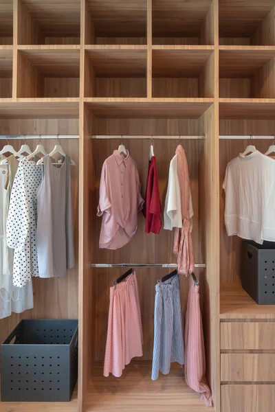 modern closet with clothes hanging