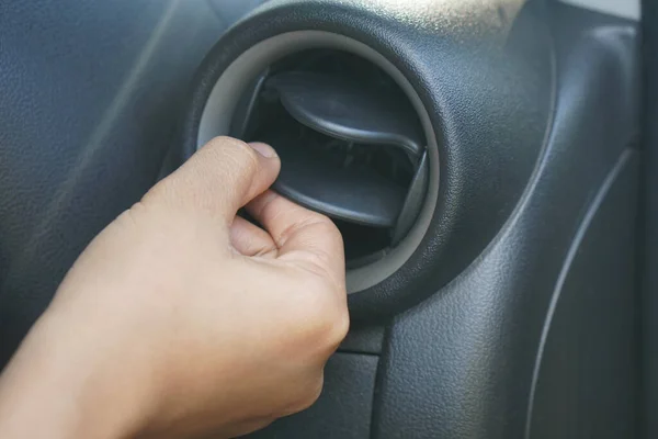 Human hand adjusted car air conditioner