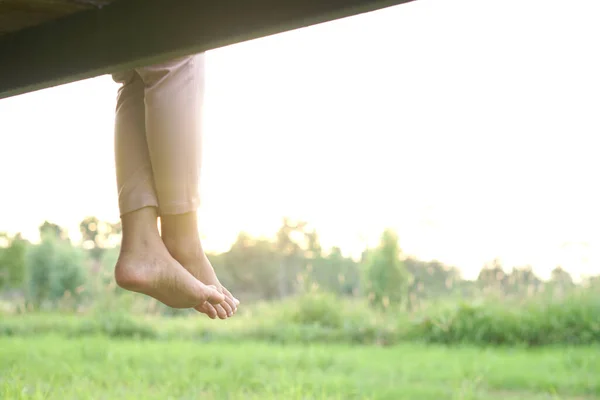 woman's feet lower from the bridge