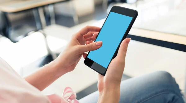 Woman using smartphone while sitting at a cafe — Stock Photo, Image