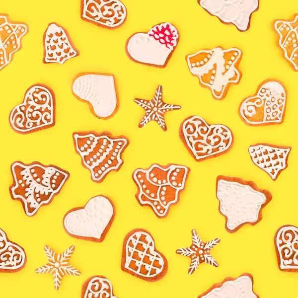 Seamless pattern square shape from Christmas gingerbreads and sweet cookies, isolated on yellow background