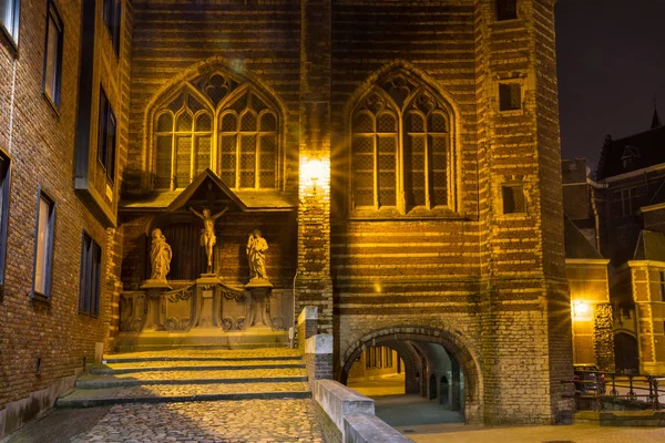 Evening cityscape - view of The Vleeshuis (Butchers Hall, or literally Meat House) and sculptural group referring to the theme of Calvary (Christ, Mary, John), in Antwerp, Belgium