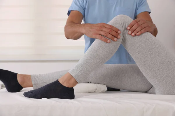 Therapist treating knee of athlete female patient , Physiotherapy, injury rehabilitation — Stock Photo, Image