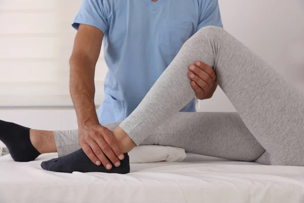 Therapist treating knee of athlete female patient , Physiotherapy, injury rehabilitation — Stock Photo, Image