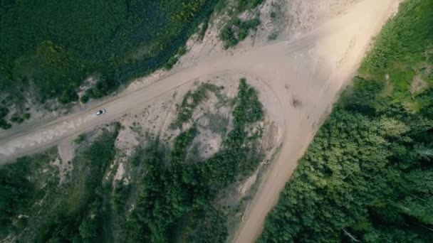 Aerial drone footage. Top view the rally car undergoes a sharp turn. — Stock Video
