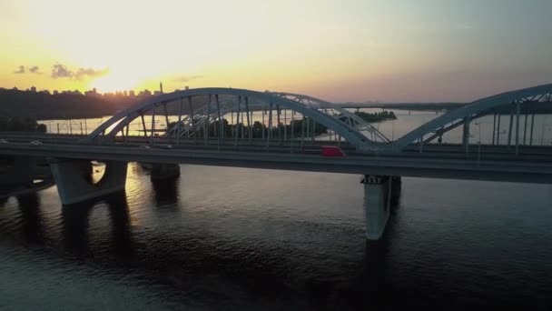 Aerial footage. Fly out Kyiv bridge at sunset. — Stock Video