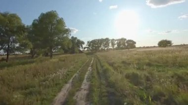 Fpv Drone yarış görünümü. Toprak yol üzerinde ve ağaçların içinden uçuş dinamiği