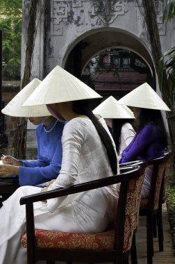 Vietnam geleneksel giysiler içinde oturan kızlar